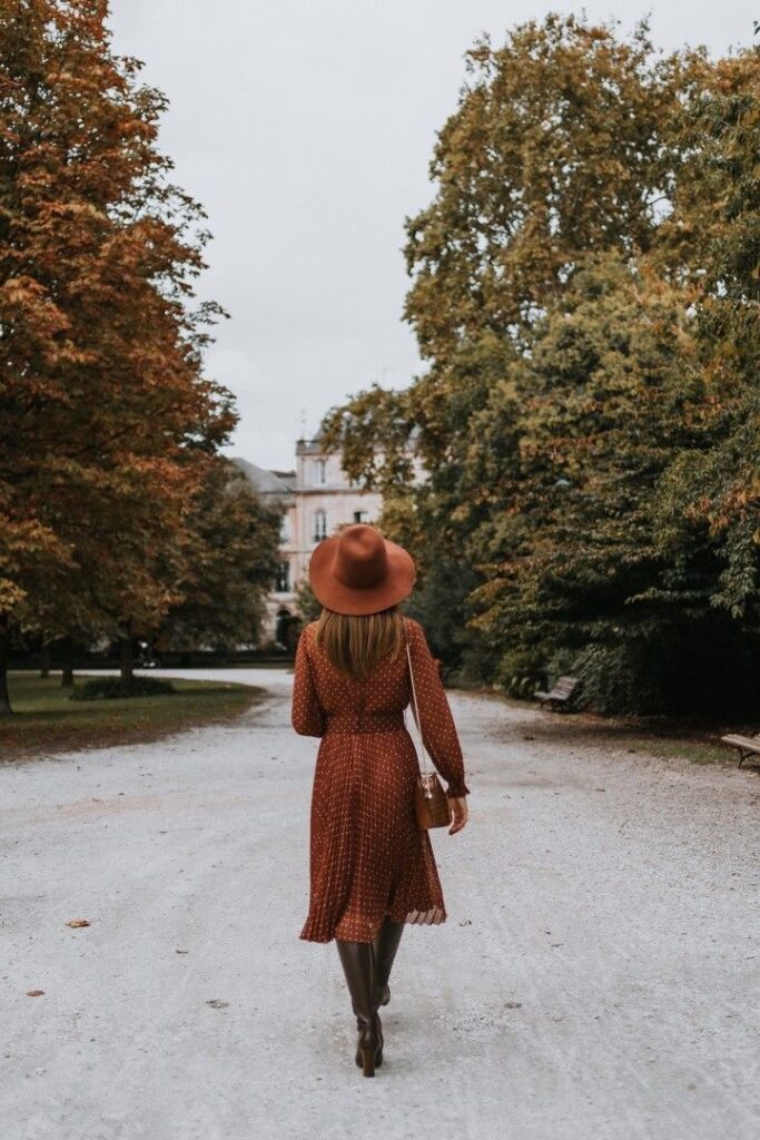 girl wearing a felt brimmed hat in fall