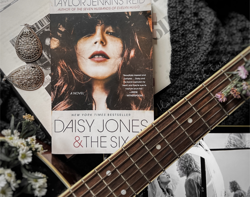 book flatlay of the book cover of Daisy Jones and the Six and Daisy with Billy from the Amazon series Daisy Jones and the Six