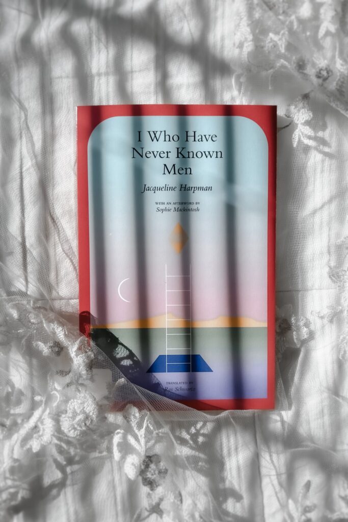 flatlay book photography of I Who Have Never Known Men Novel by Jacqueline Harpman